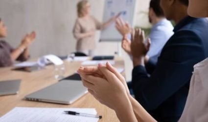 imgi_51_142770905-close-up-of-diverse-businesspeople-sit-at-desk-at-meeting-clap-hands-greeting-speaker-or-couch
